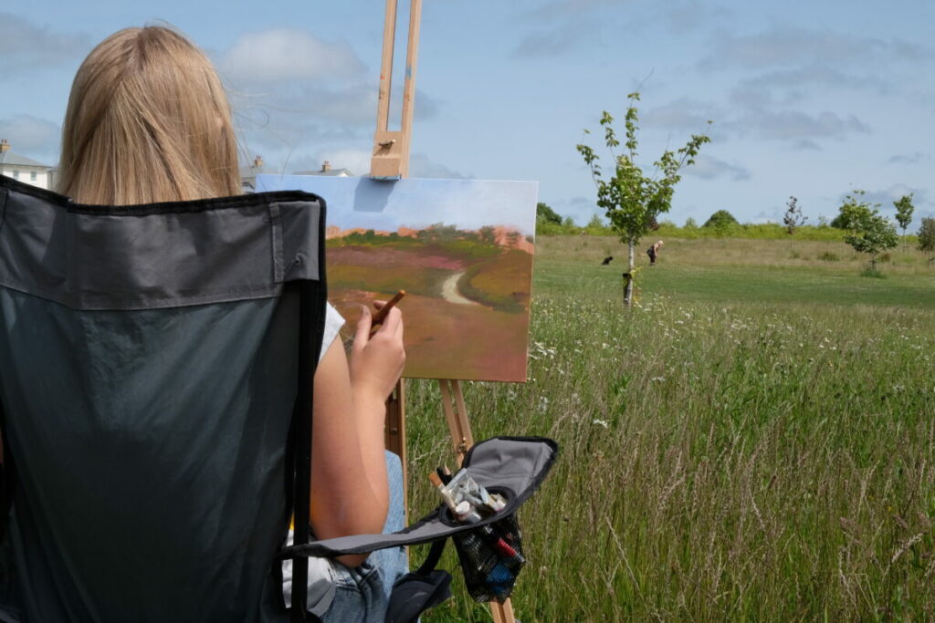 Ava painting during Art in the Park 2025